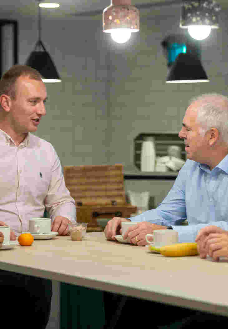 People stood talking around a table discussing business catering and food